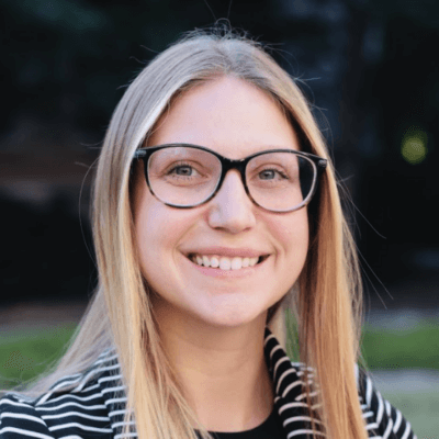 image of white woman with blond hair wearing dark rimmed glasses