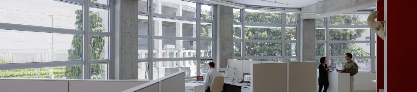 well-lit curvature of windows and cubicles in spacious Brower Center office