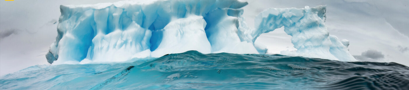 A Pristine Seas diver explores an iceberg off the Antarctic Peninsula